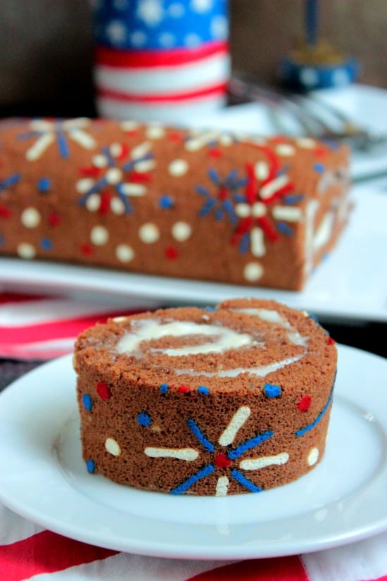 4th of July Fireworks Cake Roll on a white plate.