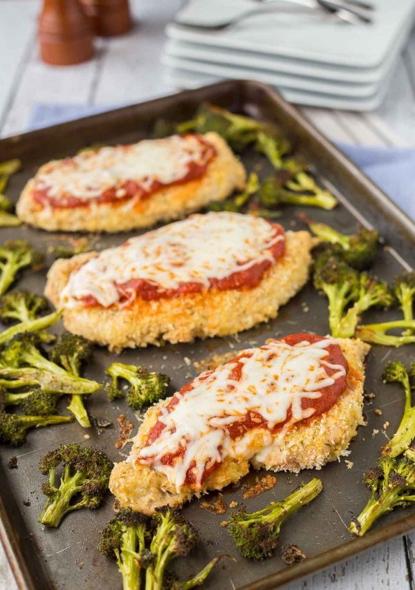 Dinner on one pan - this sheet pan baked chicken parmesan is not only healthier than the original, it's also easier! It's going to become a dinnertime fave. Get the easy dinner recipe on RachelCooks.com!