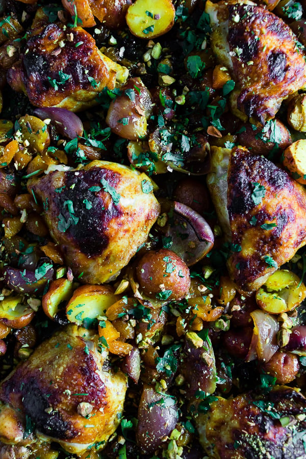This sheet pan Moroccan chicken and potatoes is flavored with lots of Moroccan spices, dried apricots, golden raisins and a sprinkling of cilantro and pistachios. This dish is super simple to make and only requires 1 sheet pan and 45-50 minutes of roasting!