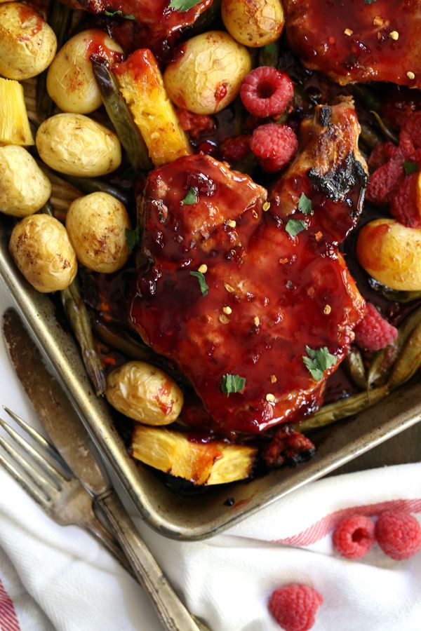 You'll never meet an easier 30 minute, one dish meal than these Sheet Pan Raspberry Pineapple Pork Chops. Thick, bone-in pork chops are roasted on a bed of potatoes and green beans that are studded with fresh raspberries and pineapple before being slathered with a raspberry pineapple sauce.