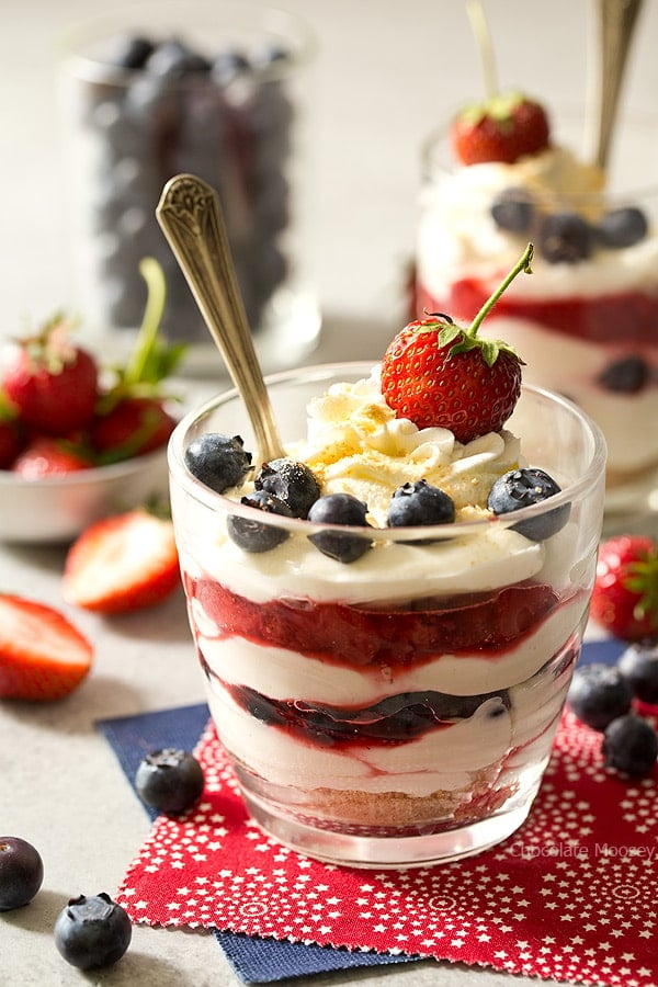 Beat the heat this summer with these red, white, and blue No Bake Mixed Berry Cheesecake Parfaits with fresh strawberries and blueberries. Made with homemade whipped cream (no Cool Whip)
