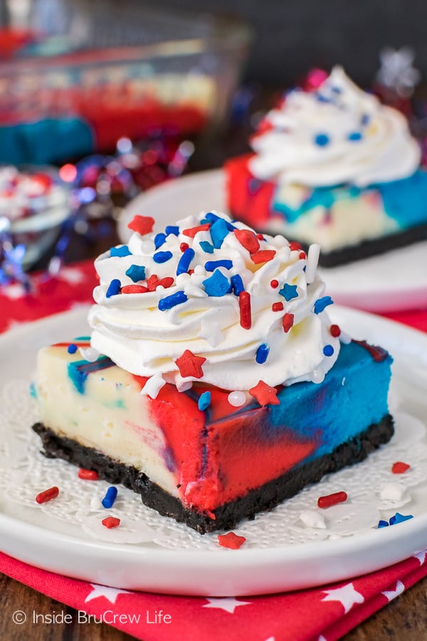 Red, White and Blue Cheesecake Bars - swirls of colors make these easy cheesecake bars a fun dessert for 4th of July parties or picnics. Easy recipe to make ahead of time!