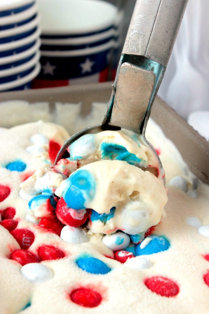Red White and Blue Peanut Butter Ice Cream - This No Churn Red White and Blue Peanut Butter Ice Cream is ready for it's debut at your next 4th of July cookout! It's creamy peanut butter ice cream loaded with red, white and blue peanut butter M&Ms!