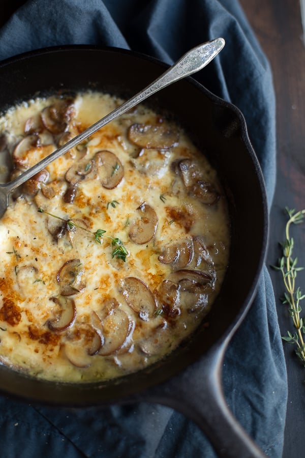 This decadent Baked Mushrooms and Fontina Dip recipe is a super easy crowd pleaser! Made with white wine and some fresh thyme, this cheesy dip has amazing flavor! | @tasteLUVnourish