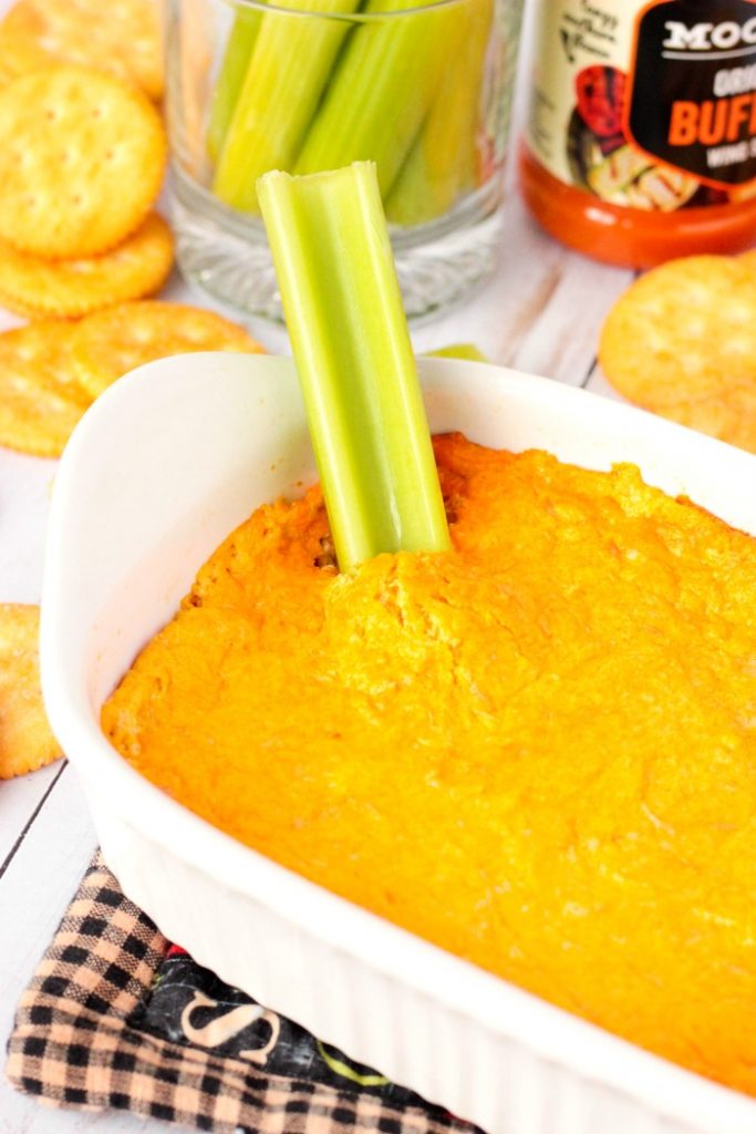 Dipping into the Buffalo Chicken Dip with celery 