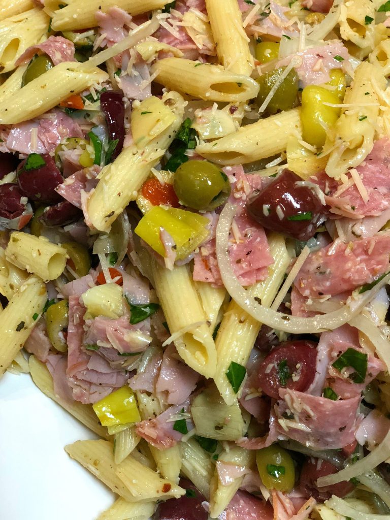 italian pasta salad with cheese and meat and homemade dressing and olives