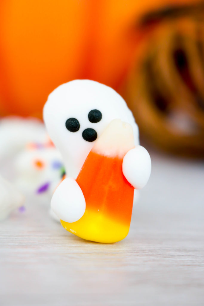 Candy Ghost holding a candy corn from Ghostly Sweet and Salty Snack Mix