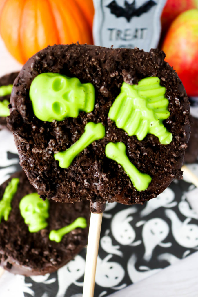 Graveyard Chocolate Apple Slices - Melted chocolate and candy skeletons decorate fresh apple slices for a tasty Halloween treats that kids and adults will love!Â  You'll love how easy theseÂ Graveyard Chocolate Apple Slices are to make and decorate too!Â 