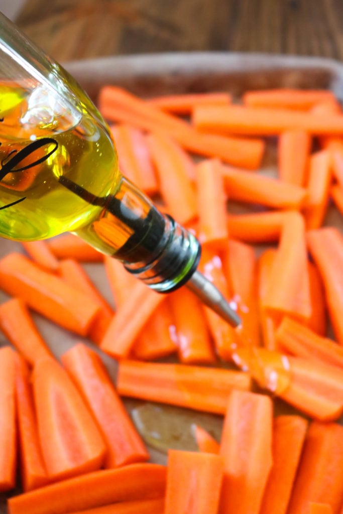 Drizzling Olive Oil On Carrots