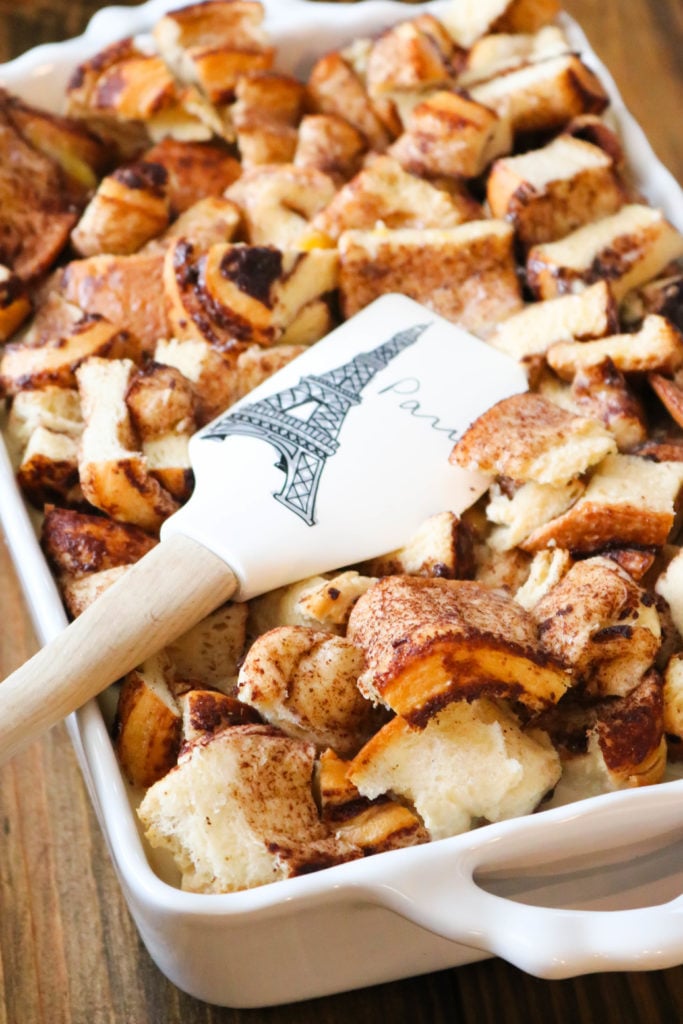 :Pressing down on Cinnamon Roll Bread Pudding with Spatula 