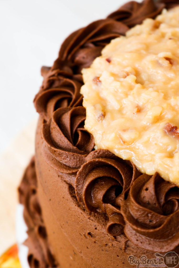 German Chocolate Cake - This German Chocolate Cake has three layers of amazing homemade chocolate cake, frosted with a homemade chocolate frosting and topped with a delicious pecan coconut filling!