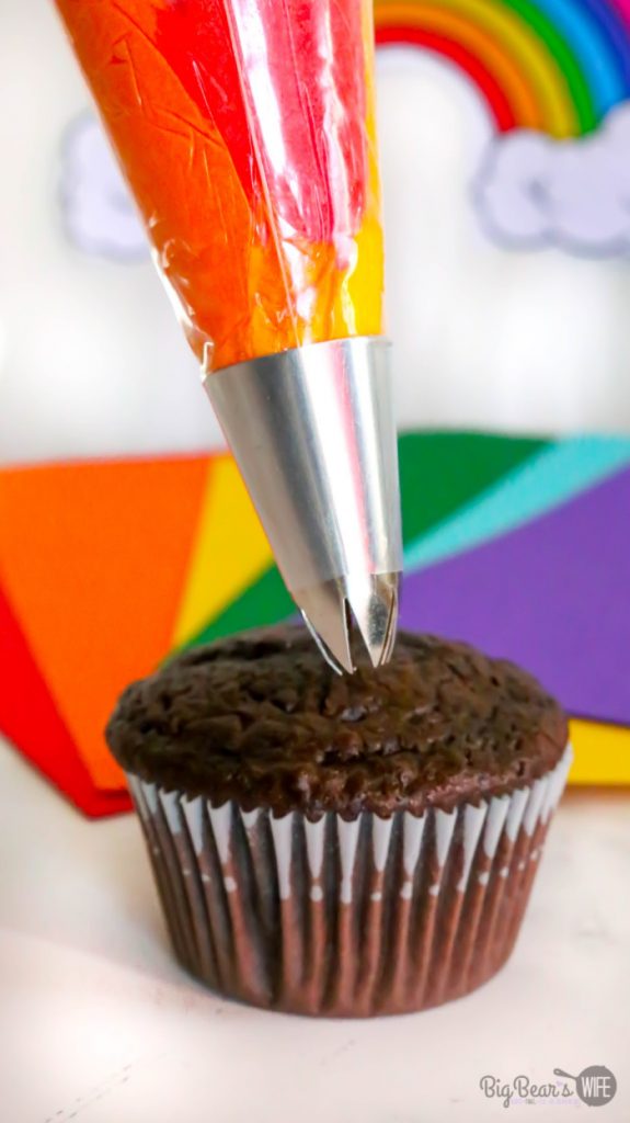 Swirling Orange Flame icing onto Homemade Mickey Mouse Rainbow Cupcakes
