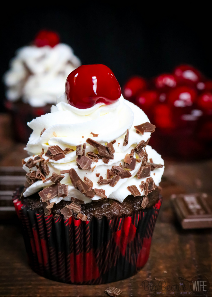 Black Forest Cupcakes - Chocolate and Cherry marry perfectly in these Black Forest Cupcakes! Chocolate cupcakes filled with cherry pie filling and topped with a homemade vanilla whipped cream frosting. 