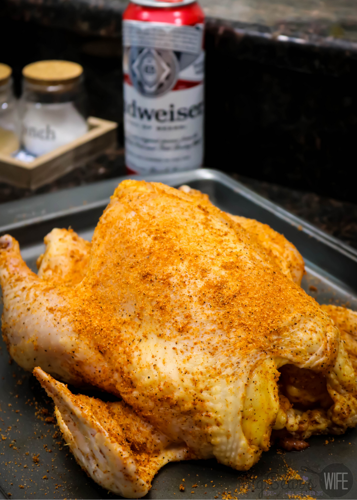 Beer Can chicken on pan with seasoning before oven