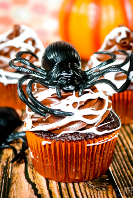 Make a spooky but tasty mess with these fun Marshmallow Spider Web Cupcakes! Homemade chocolate cupcakes and chocolate frosting get covered in creepy homemade marshmallow spiderwebs for a dessert that's perfect for Halloween! 