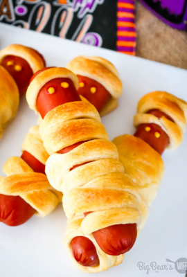 This Crescent Roll Mummy Dogs treat is a super easy savory Halloween treat! You'll need hot dogs and crescent rolls plus whatever you want to use as mummy hot dog eyes! 