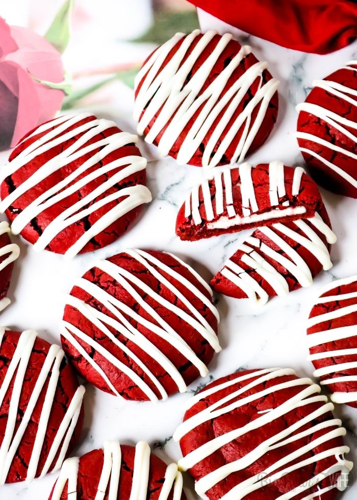 These homemade Cheesecake Stuffed Red Velvet Cookies have a red velvet cake tang and are stuffed with an easy cheesecake filling! Plus they're drizzled with melted white chocolate!