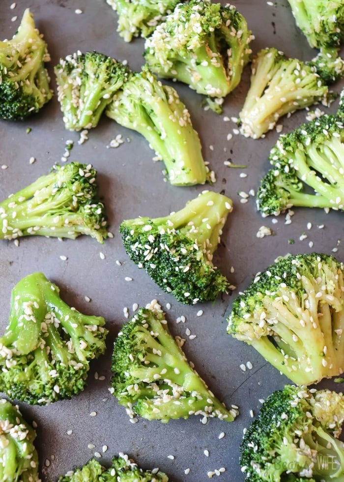 Raw Broccoli with Sesame Seeds on baking sheet