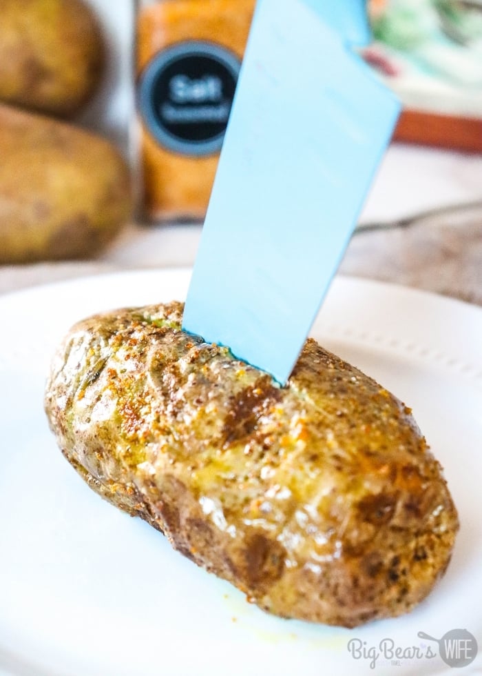 cutting Russet Baking Potato open with blue knife