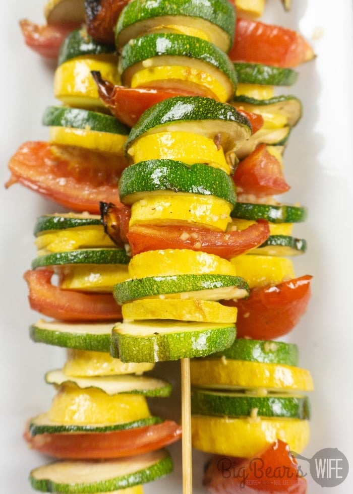 GARLIC BUTTER GRILLED VEGETABLE SKEWERS on white plate with striped napkin