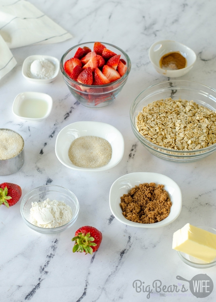 Ingredients for Homemade Strawberry Cobbler in bowls on marble table