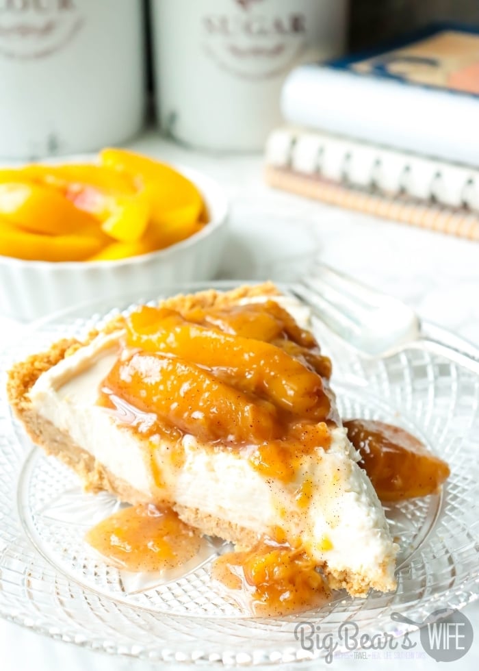Slice of Peach Cheesecake Pie on a clear plate