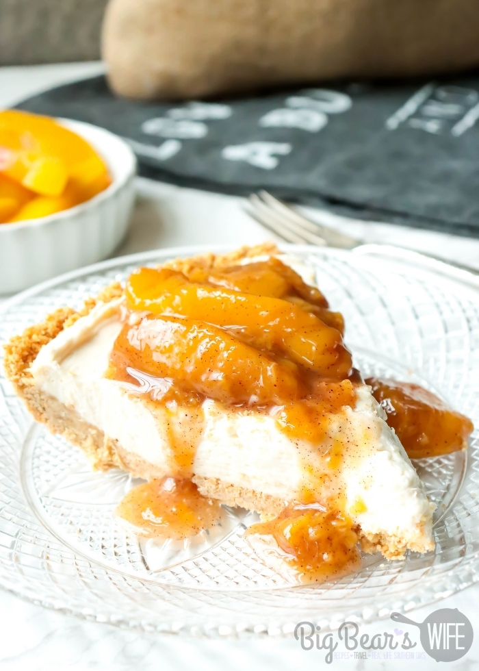 Slice of Peach Cheesecake Pie on a clear plate
