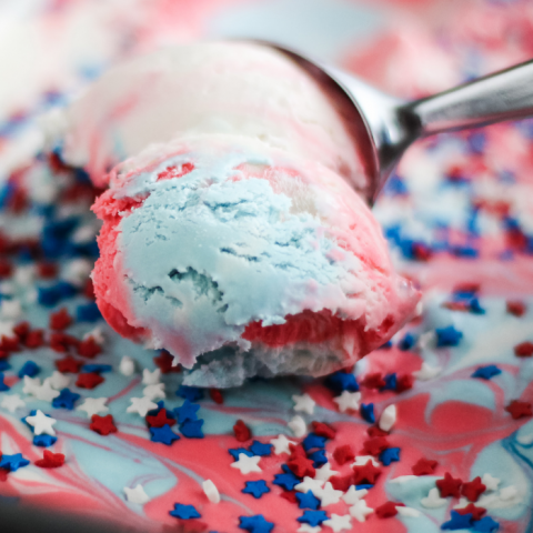 Scooping Red White and Blue Tie Dye Ice Cream in a loaf pan with sprinkles