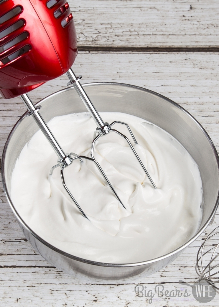 Whipping Cream in bowl with red hand held mixer