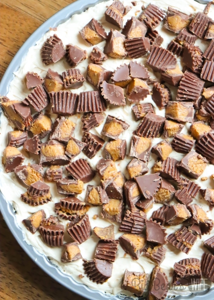 PEANUT BUTTER CHEESECAKE PIE topped with chopped peanut butter cups