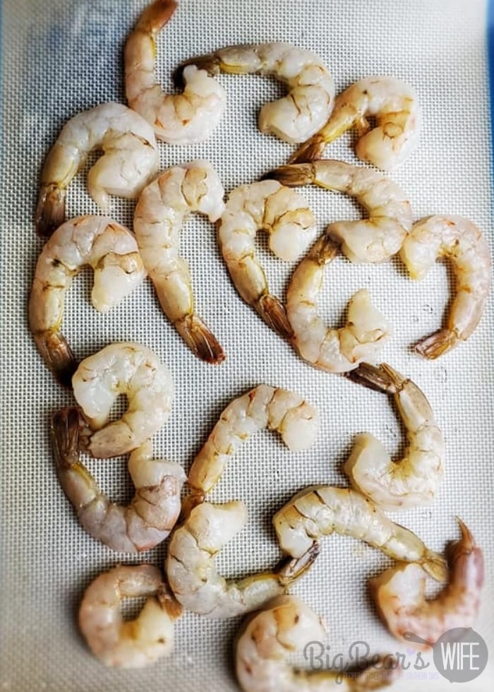 raw shrimp on baking sheet