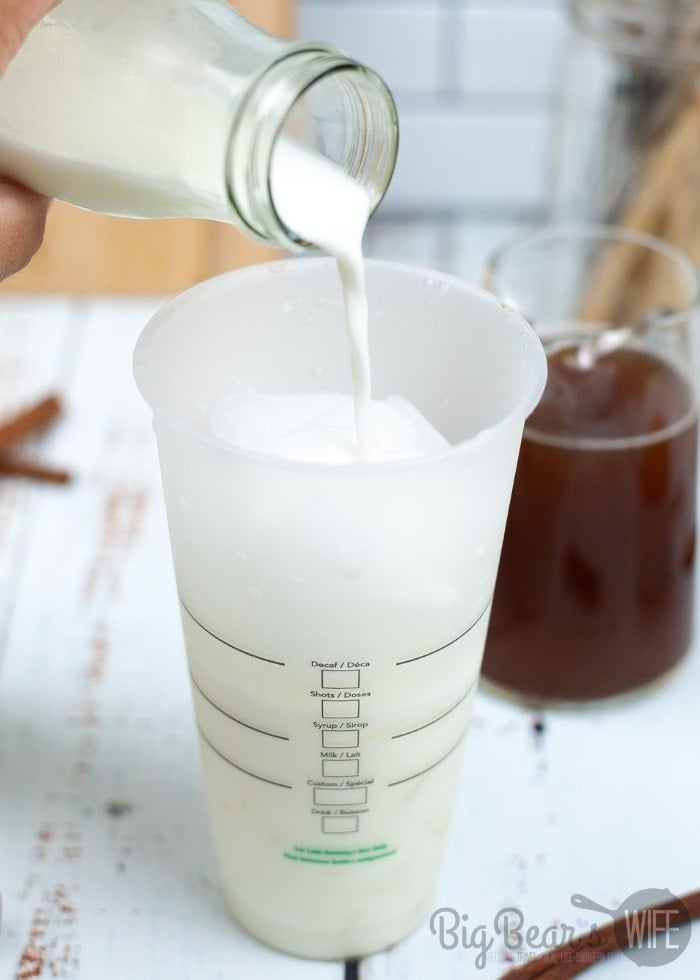 In a 24 ounce cup filled 2/3 full of ice, add the milk