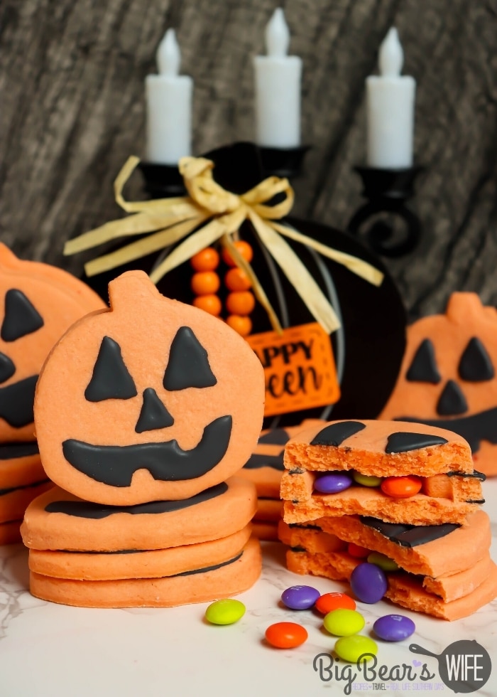 Pumpkin Piñata Cookies - homemade orange sugar cookies stacked together, decorated like Jack-O-Lanterns and filled with Halloween candy! 