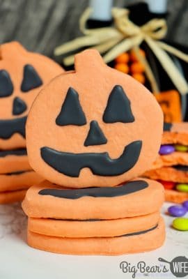 Pumpkin Piñata Cookies - homemade orange sugar cookies stacked together, decorated like Jack-O-Lanterns and filled with Halloween candy!