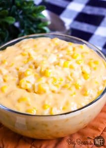 HOMEMADE CHEESY CREAMED CORN in clear bowl with dried parsley (1)