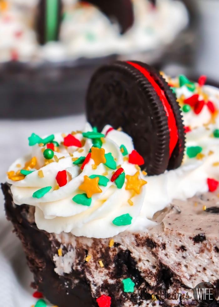 close up of side of Slice of HOLIDAY OREO PIE on a white plate with Christmas sprinkles