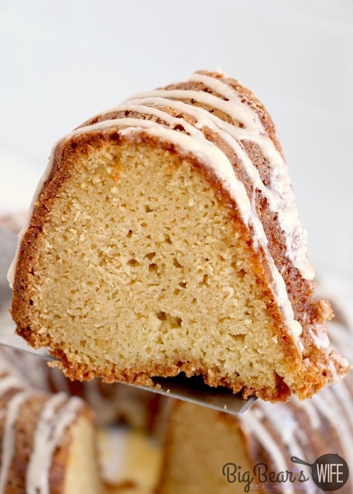 serving a slice of EGGNOG POUND CAKE with whole cake in background