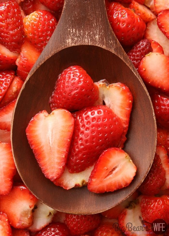 sliced strawberries in a wooden spoon