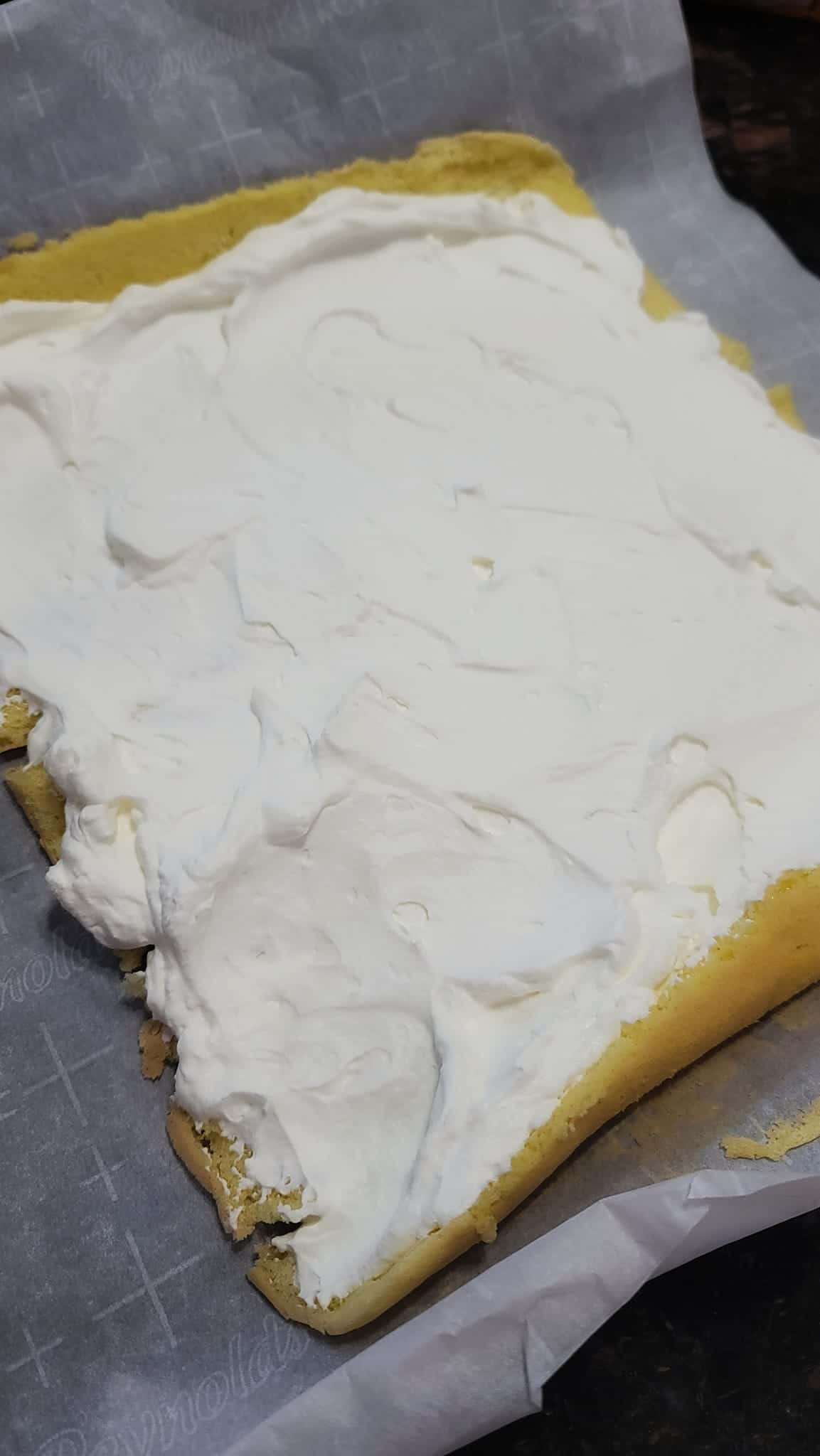 whipped cream spread on sponge cake