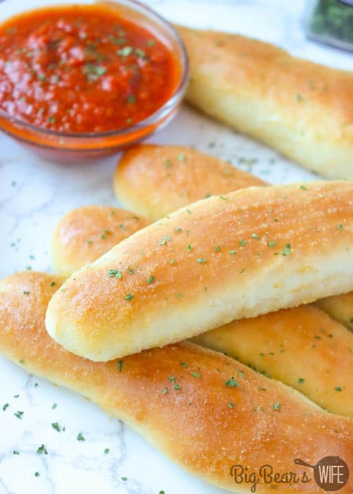 COPYCAT OLIVE GARDEN BREADSTICKs with pizza sauce in the background (2)