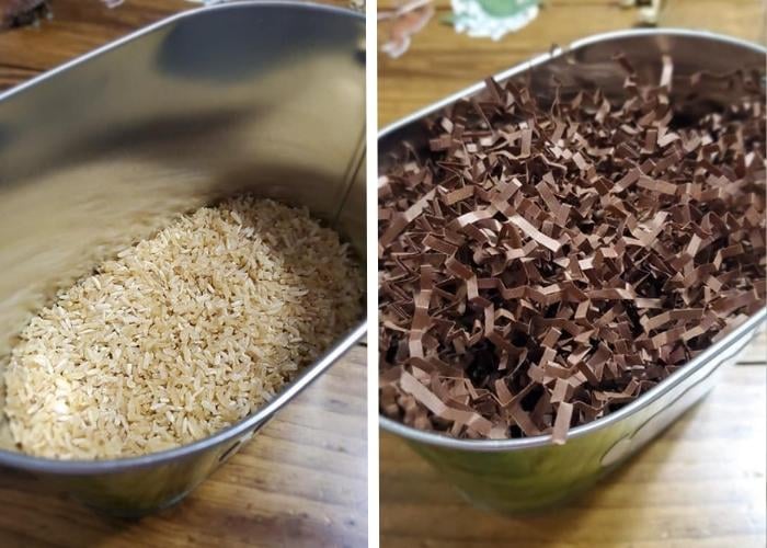 Rice in a bucket on the left and brown paper in a bucket on the right