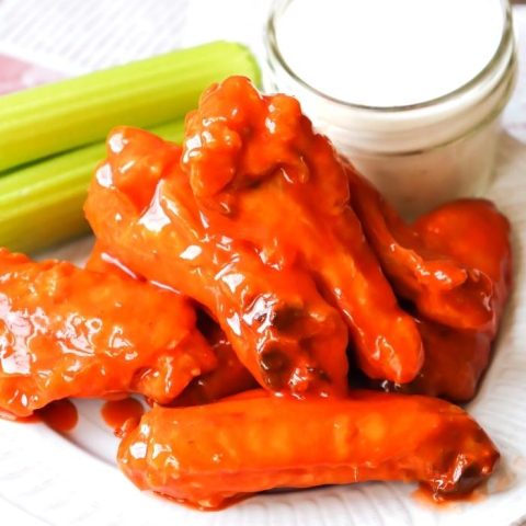 Air Fryer Buffalo Wings on white plate with ranch and celery (1)