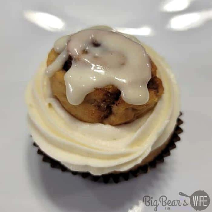 mini cinnamon roll on top of cupcake with frosting on top