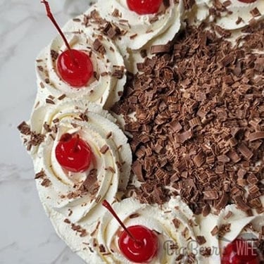 Add chocolate curls to side of cake and sprinkle on top. 