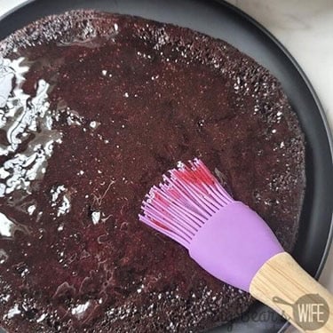 Brush both cakes with the cherry syrup. Let sit for 2-3 minutes.