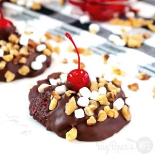 Bring the ice cream parlor home with these fun Chocolate Sundae Cookies! Homemade Chocolate cookies with cherries are topped with melted chocolate, marshmallows, walnuts and a cherry! 