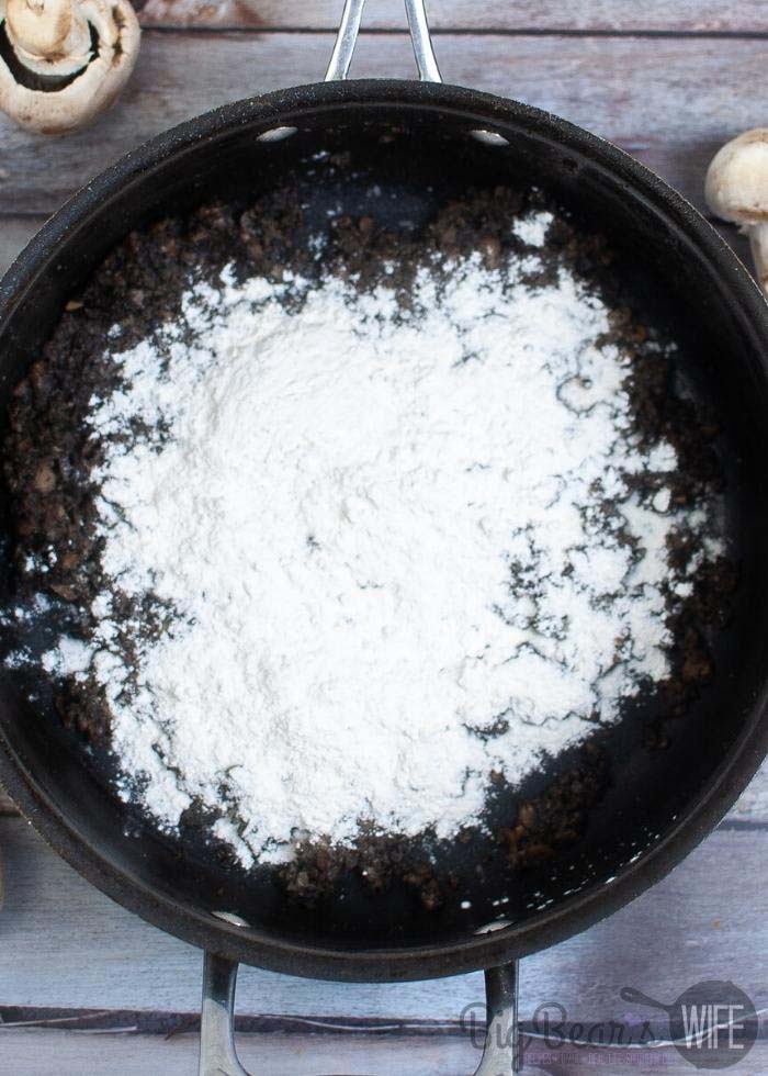 mushrooms in skillet with flour added