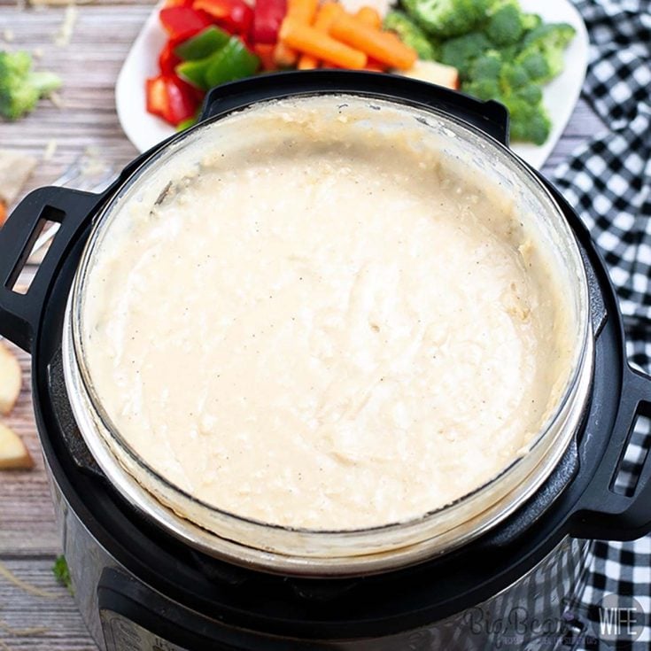 Ready for a fondue night at home? This Instant Pot Melting Pot inspired Cheese Fondue is ready in about 30 minutes and perfect for dipping breads, fruits and cooked meats!
