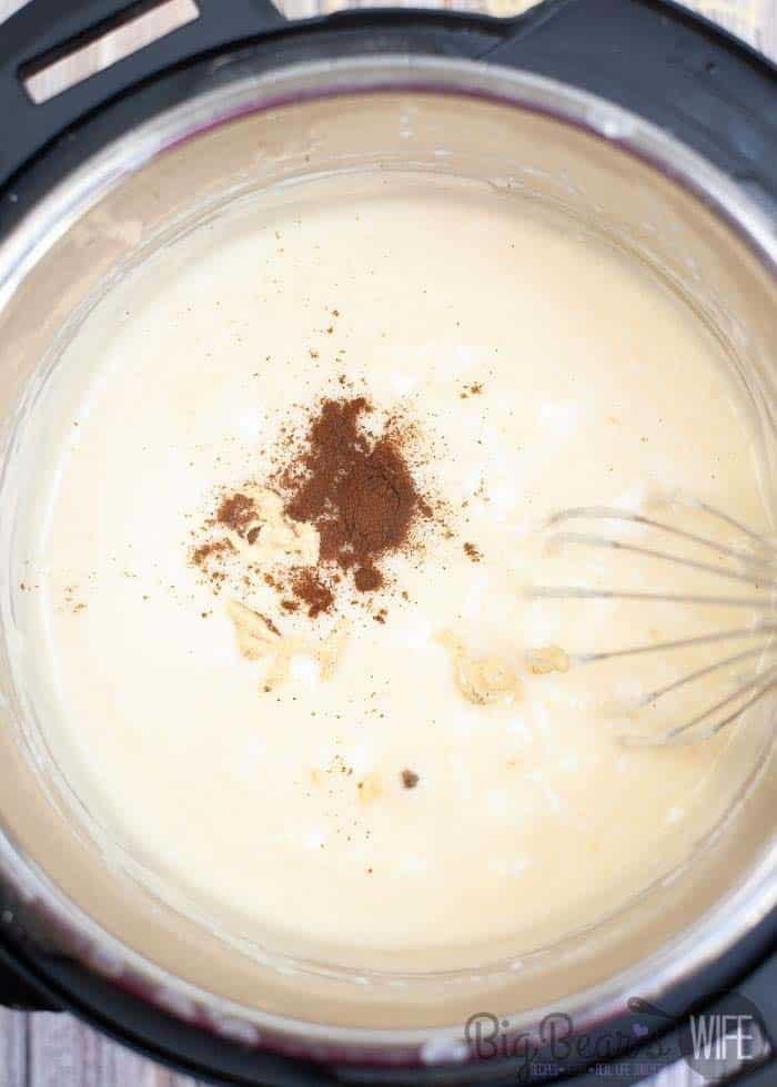adding nutmeg and mustard to cheese dip