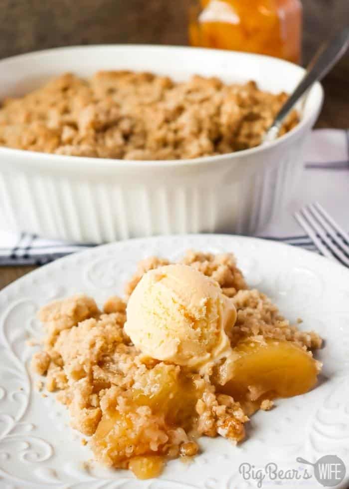 Serving of Easy Apple Dump Cake on white plate with vanilla ice cream on top